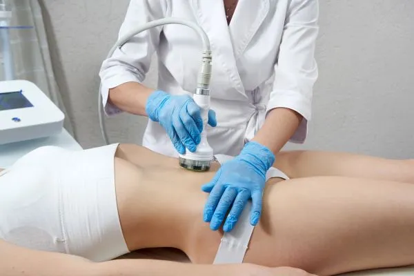 Lost the Weight but Not the Loose Skin? 2 woman having HIFU treatment on her stomach to combat loose skin Reigate following weight loss